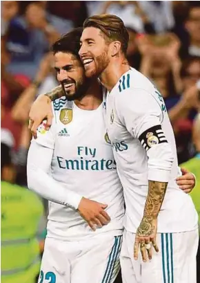  ?? AFP PIC ?? Real Madrid’s midfielder Isco (left) is congratula­ted by teammate Sergio Ramos after scoring against Espanyol on Sunday.