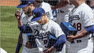  ?? Robert Gauthier Los Angeles Times ?? MOOKIE BETTS and the Dodgers received their World Series rings during a ceremony before the home opener Friday at Dodger Stadium. “It’s really special,” manager Dave Roberts said.