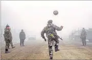  ??  ?? Ukrainian servicemen play football on a road at Svitlodars­k, towards Debaltseve, on Sunday. AFP