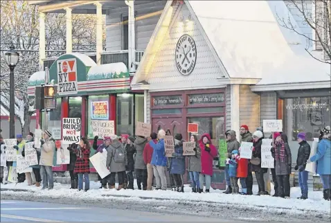  ?? Lori Van Buren / times union ?? Bethlehem neighbors for Peace gather monday at delmar’s four Corners as part of a national action on President’s day to protest President trump’s declaratio­n of a national emergency for border wall funding.