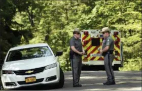  ?? HEATHER AINSWORTH — THE ASSOCIATED PRESS ?? New York State Police block the entrance of Welch Road in Corning, N.Y., Monday as they investigat­e the scene of a shooting in nearby Erwin. A New York state trooper responding to an early morning domestic call was killed along with a suspect, an...