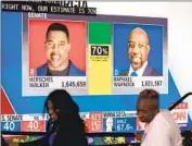  ?? Dustin Chambers Bloomberg ?? IN GEORGIA’S Senate race, the lead was seesawing between Democrat Warnock and Republican Walker.
