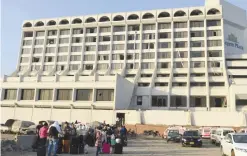  ??  ?? KARACHI: Guests are gather outside a Regent Plaza Hotel following a fire in the Pakistan’s port city of Karachi yesterday. — AFP