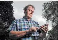  ?? AP/MORRY GASH ?? Towne & Country
Building Inspection owner Scot McLean looks at his calendar outside his Fox Point, Wis., home last month. In July, Towne & Country was hacked, wiping out its reservatio­ns calendar.