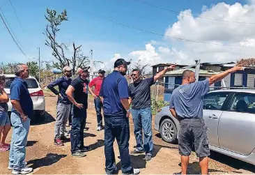  ?? [PHOTO BY THE BAPTIST MESSENGER] ?? In this 2017 photo, the Rev. Felix Cabrera, center, visits his native Puerto Rico to help in the aftermath of Hurricane Maria.