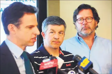  ?? Ned Gerard / Hearst Connecticu­t Media ?? Ian Hockley, center, father of Sandy Hook Elementary School student Dylan Hockley, and Bill Sherlach, right, husband of Sandy Hook school psychologi­st Mary Sherlach, look on as attorney Josh Koskoff speaks during a news conference in Bridgeport in March.