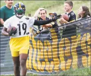  ?? Keith Srakocic / Associated Press ?? Steelers wide receiver JuJu Smith-Schuster talks with some young fans along the fence line during drills last summer in Latrobe, Pa.