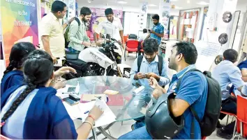  ?? —DC ?? Customers purchasing two-wheelers at the TVS showroom in Kukatpally at 10 pm on Thursday.