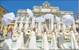  ?? AFP ?? ■
LET US TIE THE KNOT: Women hold a protest by the Trevi fountain in Rome against the postponeme­nt of their weddings due to strict curbs on ceremonies amid the coronaviru­s pandemic.