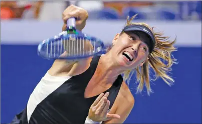  ?? The Associated Press ?? Maria Sharapova, of Russia, returns a shot to Carla Suarez Navarro, of Spain, during their fourth-round match at the U.S. Open in New York on Monday. Sharapova lost 6-4, 6-3.