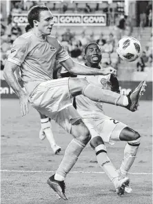  ?? Michael Wyke photos / Contributo­r ?? Forward Andrew Wenger, left, puts his best foot forward for the Dynamo against the Union’s Raymon Gaddis. Wenger believes the Dynamo have what it takes to make the playoffs.