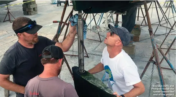  ??  ?? Brandon (left) and Phillip re-install the rudder toward the end of the project