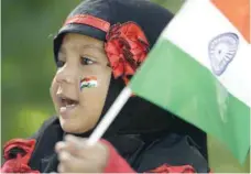  ?? — AFP ?? A girl holds a national flag during Independen­ce Day celebratio­ns in Secunderab­ad.