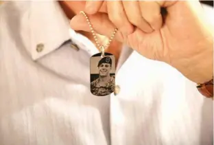  ?? Associated Press ?? Brian McEnroe, the father of fallen U.S. Green Beret Kevin McEnroe, displays a memorial dog tag depicting his fallen son on June 17 in Amman, Jordan. First Sgt. Marik al-Tuwayha, the Jordanian soldier charged with killing three U.S. Army Green Berets...