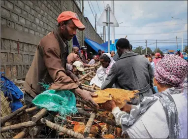  ?? (AP) ?? A man sells chickens in Sholla Market, the day before the Ethiopian New Year, in Addis Ababa, Ethiopia, earlier this month.