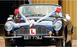  ??  ?? Britain’s Prince William and his wife Catherine drive from Buckingham Palace in an Aston Martin DB6 Mark 2, after their wedding in central London on April 29, 2011. (Reuters)