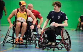  ?? Photograph: Christophe­r Thomond/The Guardian ?? Aaron Bower (left) gets to grips with the intricacie­s of wheelchair rugby league with the England squad.