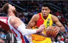  ?? PAUL SANCYA/FILES ?? Milwaukee Bucks forward Giannis Antetokoun­mpo, right, who hails from Greece, is just one of a number of foreign-born players who are making an indelible mark in the NBA.