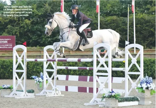  ??  ?? James Smith and Twix De La Roque storm round the grand prix jump-off to win by nearly four seconds