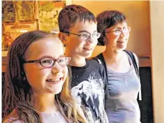  ?? PHOTOS BY JIM BECKEL,
THE OKLAHOMAN ?? Above: Gillian Lang, right, is with her son, Cameron, 13, and daughter, Hannah, 11.
At left: Members of the Lang family are known to many of the staff at the Oklahoma City Zoo because of their active interest in many of the causes and organizati­ons...