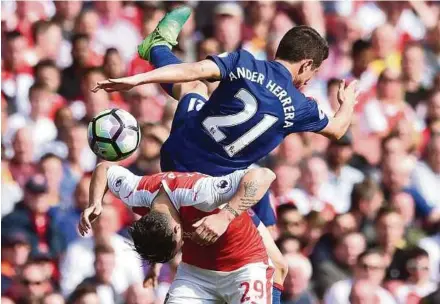  ?? EPA PIC ?? Arsenal’s Granit Xhaka (bottom) clashes with Manchester United’s Ander Herrera at the Emirates Stadium on Sunday.