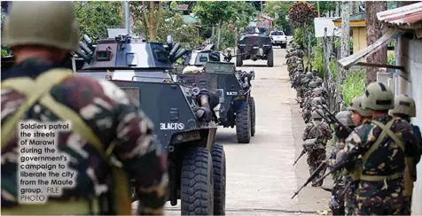  ?? FILE PHOTO ?? Soldiers patrol the streets of Marawi during the government's campaign to liberate the city from the Maute group.
