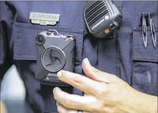  ??  ?? Officer Aramis Grigorian of the Boynton Beach Police Department demonstrat­es the new Axon Body 2 body cameras that the department’s officers will now be wearing when at work in the field.