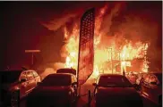  ?? NOAH BERGER / ASSOCIATED PRESS ?? Flames consume a car dealership Thursday in the Northern California town of Paradise. The wildfire has leveled much of the town.