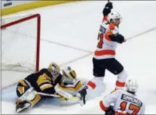  ?? GENE J. PUSKAR — THE ASSOCIATED PRESS ?? The Flyers’ Scott Laughton (21) begins to celebrate after a shot by Sean Couturier got past Pittsburgh Penguins goaltender Matt Murray (30) during the third period in Game 5 Friday in Pittsburgh.