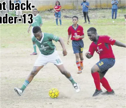  ?? (Photo: Paul Reid) ?? Joshaun Whittaker (right) of Howard Cooke Primary tries to get past Green Pond Primary’s Usain Stern in their St James FA Under-13 football game played at Corinaldi Avenue Primary in Montego Bay. Green Pond Primary won 3-0.