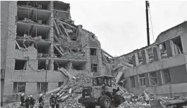  ?? GENYA SAVILOV/AFP VIA GETTY IMAGES ?? Ukrainian rescuers clear the rubble of a destroyed building following a missile attack in Chernihiv on Wednesday. Germany has launched a plea for allies to bolster Ukraine’s stressed air defense systems.