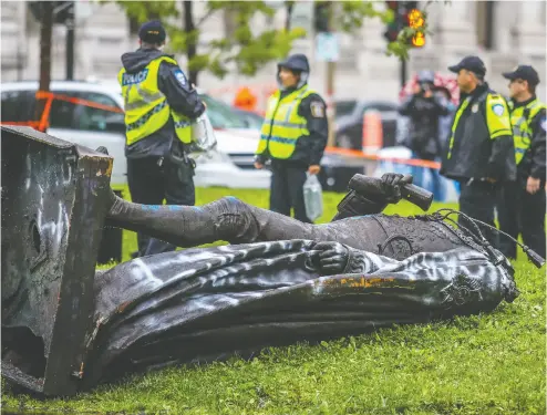  ?? John Mahoney / postmedia news files ?? The headless statue of Sir John A. Macdonald on the ground in Montreal after a demonstrat­ion in August.