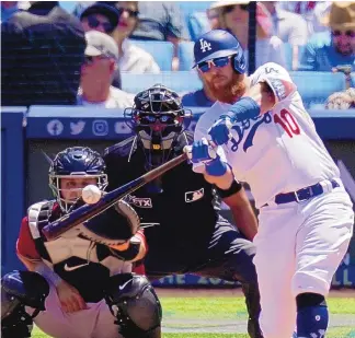  ?? MARK J. TERRILL/ASSOCIATED PRESS ?? The Dodgers’ Justin Turner hits a three-run home run during the fourth inning of Wednesday’s victory against the Arizona Diamondbac­ks in Los Angeles.
