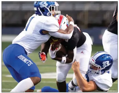  ?? (Arkansas Democrat-Gazette/Justin Cunningham) ?? Bryant defenders Malachi Graham (left) and Sebastian Oltmans tackle Little Rock Parkview running back Cameron Settles during their game earlier this season. Graham, the 2021 championsh­ip game Most Valuable Player, will help lead the Hornets in today’s Class 7A title game against Bentonvill­e.