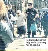  ??  ?? Pc Cullen helps the lady while carrying her shopping