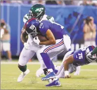  ?? Al Bello / Getty Images ?? Golden Tate of the New York Giants makes a catch while defended by the Jets’ Neville Hewitt during a preseason game at MetLife Stadium on Thursday in East Rutherford, N.J.