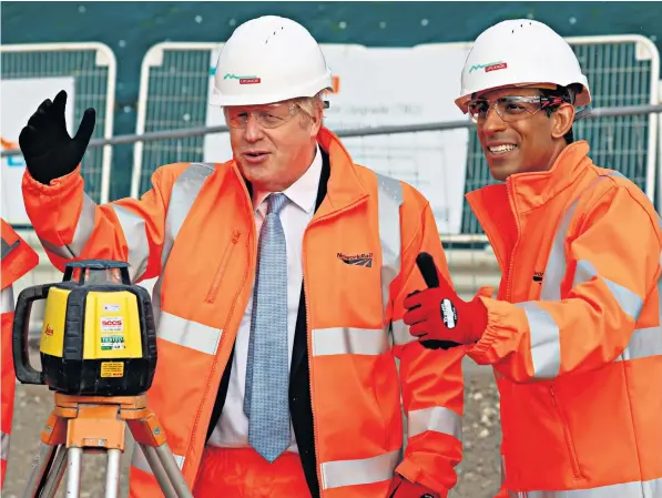  ?? ?? Boris Johnson and Rishi Sunak visit Network Rail’s Miles Platting compound to learn about the infrastruc­ture improvemen­ts being made in the North