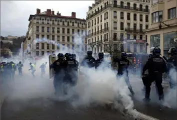  ?? Laurent Cipriani/Associated Press ?? Police officers clash with demonstrat­ors in Lyon, central France, on Saturday.