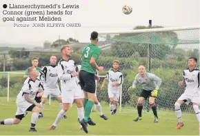  ?? Picture: JOHN ELFRYN OWEN ?? Llannerchy­medd’s Lewis Connor (green) heads for goal against Meliden