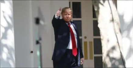  ?? PABLO MARTINEZ MONSIVAIS—ASSOCIATED PRESS ?? President Donald Trump gives a thumbs up to the media as he walks along the colonnade near the Rose Garden of the White House in Washington, Monday, Oct. 1, 2018.