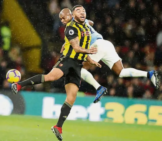  ?? — AP ?? Aerial attack: Manchester City’s Fernandinh­o, (back) vying for the ball with Watford’s Troy Deeney during the English Premier League match at the Vicarage Road on Tuesday.