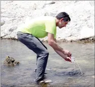  ?? LYNN KUTTER ENTERPRISE-LEADER ?? Dr. Brian Haggard, director of Arkansas Water Resource Center with University of Arkansas, takes a sample of water from a tributary that flows into the Illinois River. He sampled six sites located upstream and downstream from the sewer system that...