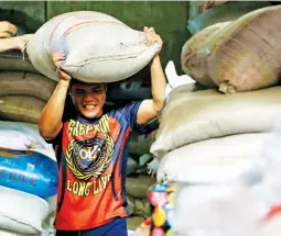  ?? (Mark Balmores) ?? SUGAR STOCKS – A worker arranges sacks of sugar in a store at the Marikina Public Market in Marikina City on Monday, May 13, 2024. Sugarcane producers warned of a potential sugar shortage and urged the government to import around 200,000 metric tons to fill the gap caused by severe damage to Negros' plantation­s due to El Niño.