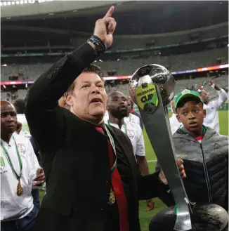  ??  ?? A NIGHT TO REMEMBER: Free State Stars coach Luc Eymael celebrates with the Nedbank Cup trophy at Cape Town Stadium on Saturday.