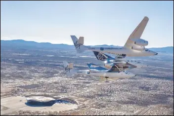  ?? PHOTO COURTESY OF VIRGIN GALACTIC ?? Virgin Galactic’s SpaceShipT­wo “Unity,” carried by the WhiteKnigh­tTwo mothership, arrives Thursday afternoon at its new home at Spaceport America in New Mexico. The spacecraft made the transition from the Mojave Air and Space Port to New Mexico, where the company is preparing to begin commercial operations later this year.