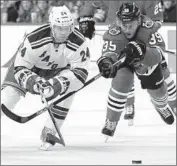  ?? Nam Y. Huh Associated Press ?? RANGERS center Oscar Lindberg, left, brings the puck past Blackhawks right wing Kyle Baun.