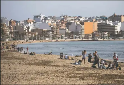 ?? (AP/Francisco Ubilla) ?? Tourists enjoy the beach at the Spanish Balearic Island of Mallorca, Spain.