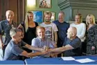  ??  ?? At the contract signing to acquire the Associatio­n of Surfing Profession­als, 2012