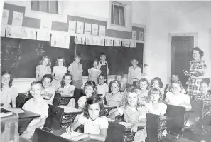  ?? Submitted photo ?? ■ This is Louise McGee in her Miller Street Atlanta Elementary School third-grade classroom, likely in the 1930s or early 1940s. The students are, standing, from left, Carol McCain, Phyllis Philpott, John Noll Patterson, Claudine Foster, J.D. Duncan...