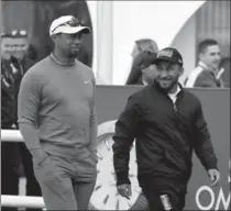  ?? ROSS KINNAIRD, GETTY IMAGES ?? Tiger Woods arrives at the Emirates Golf for a short visit during the second round of the Omega Dubai Desert Classic Friday. THE ASSOCIATED PRESS